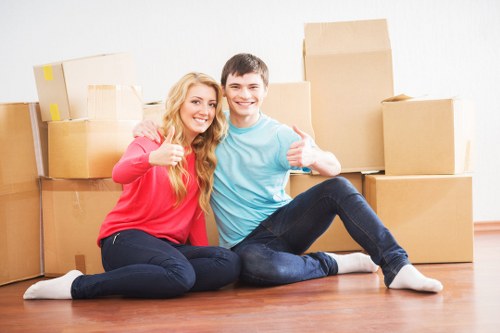 Professional movers carrying furniture in an apartment building